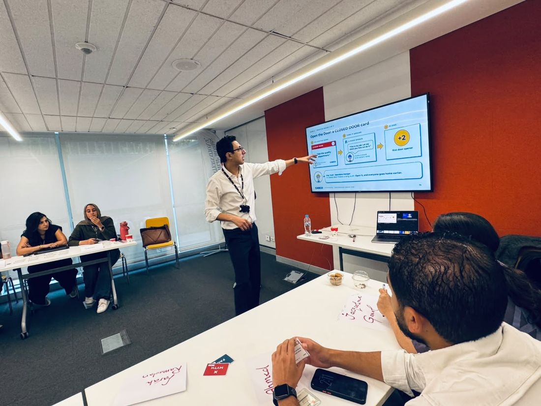 The trainer pointing at the slide